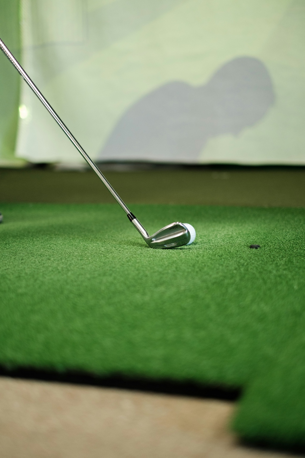 Golf ball and club on putting turf